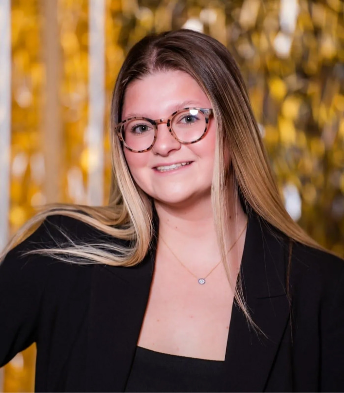 Sophia smiling while wearing her black suit.