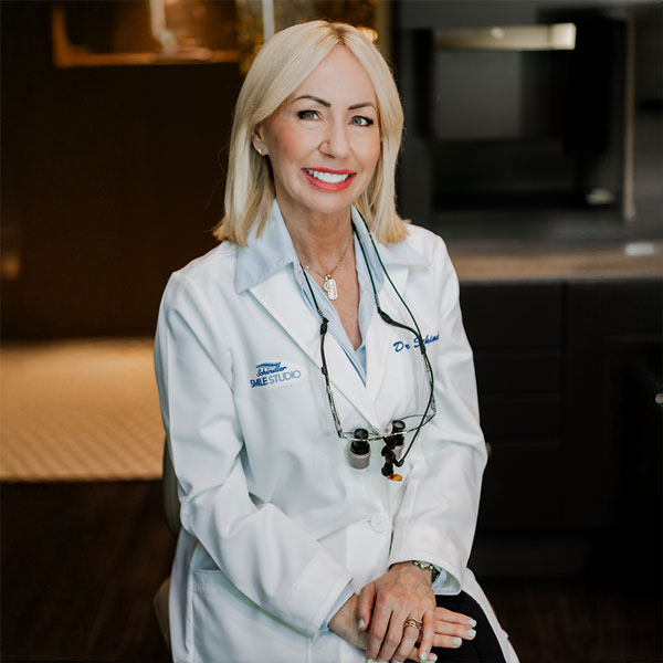 Dr. Schindler smiling while sitting in the office.